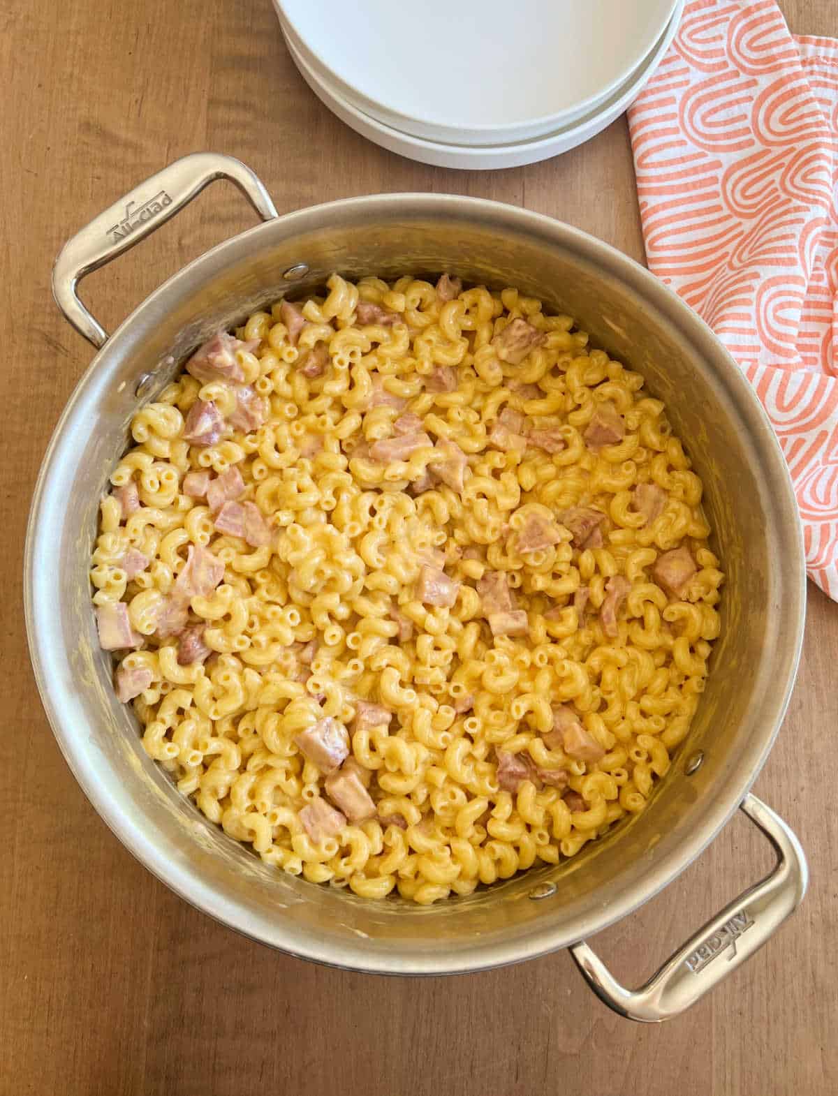large pot with macaroni and cheese with ham on table.