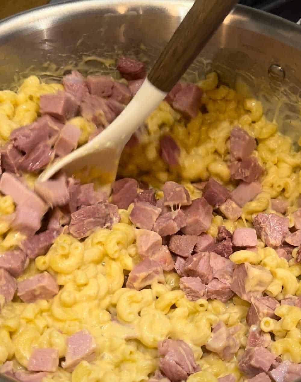 stir cooked ham into macaroni.