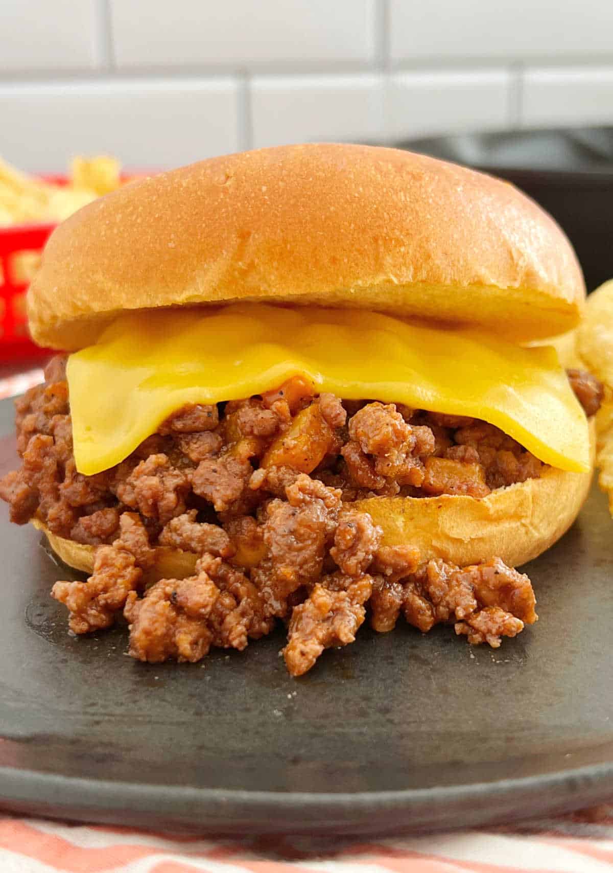 Sloppy Joe sandwich on brioche bun with American cheese.