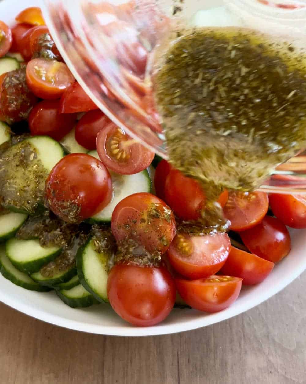 pour dressing over salad ingredients.