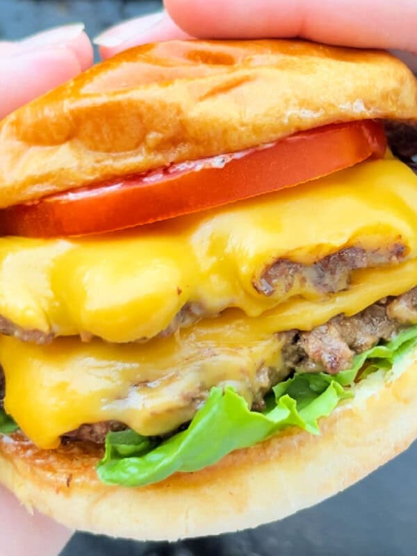 double smash burger with cheese in hand.