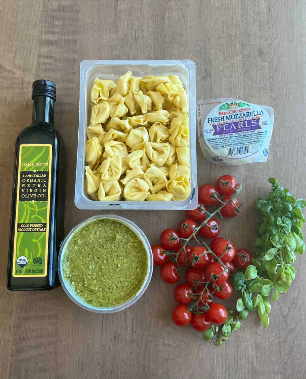fresh tortellini, olive oil, mozzarella pearls, pesto, cherry tomatoes and fresh basil.