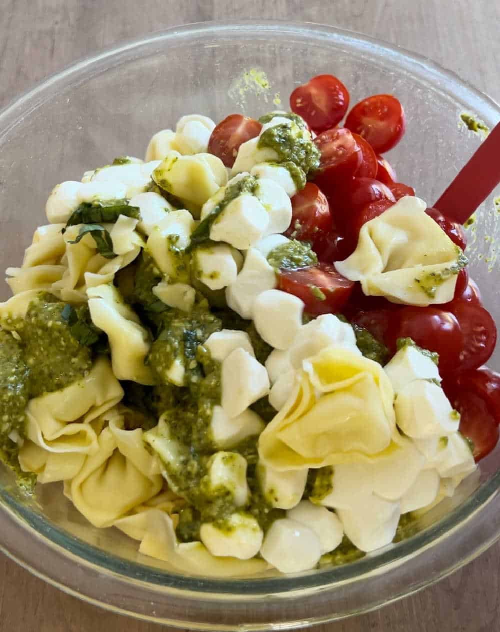 stir pesto sauce with salad.