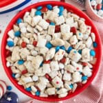 red white and blue puppy chow with patriotic m&m's and chex cereal in a red bowl.