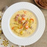 ham and potato soup in a white bowl.