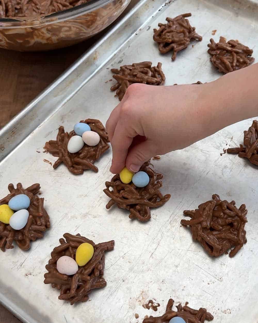 place candy eggs in nests.