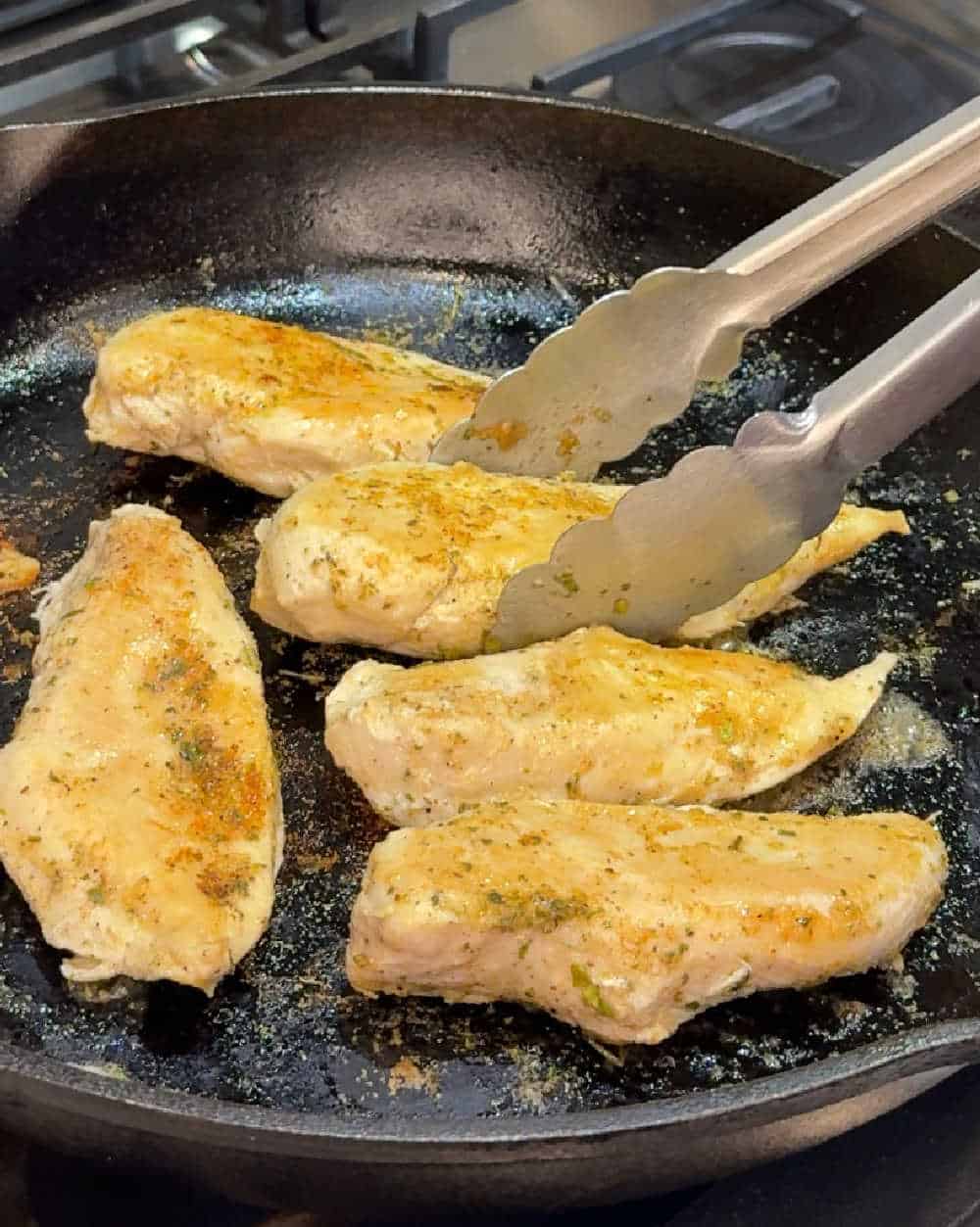 browned chicken breast in skillet.