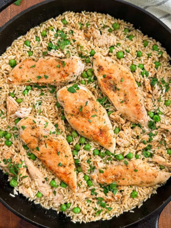 chicken and rice with peas in skillet.