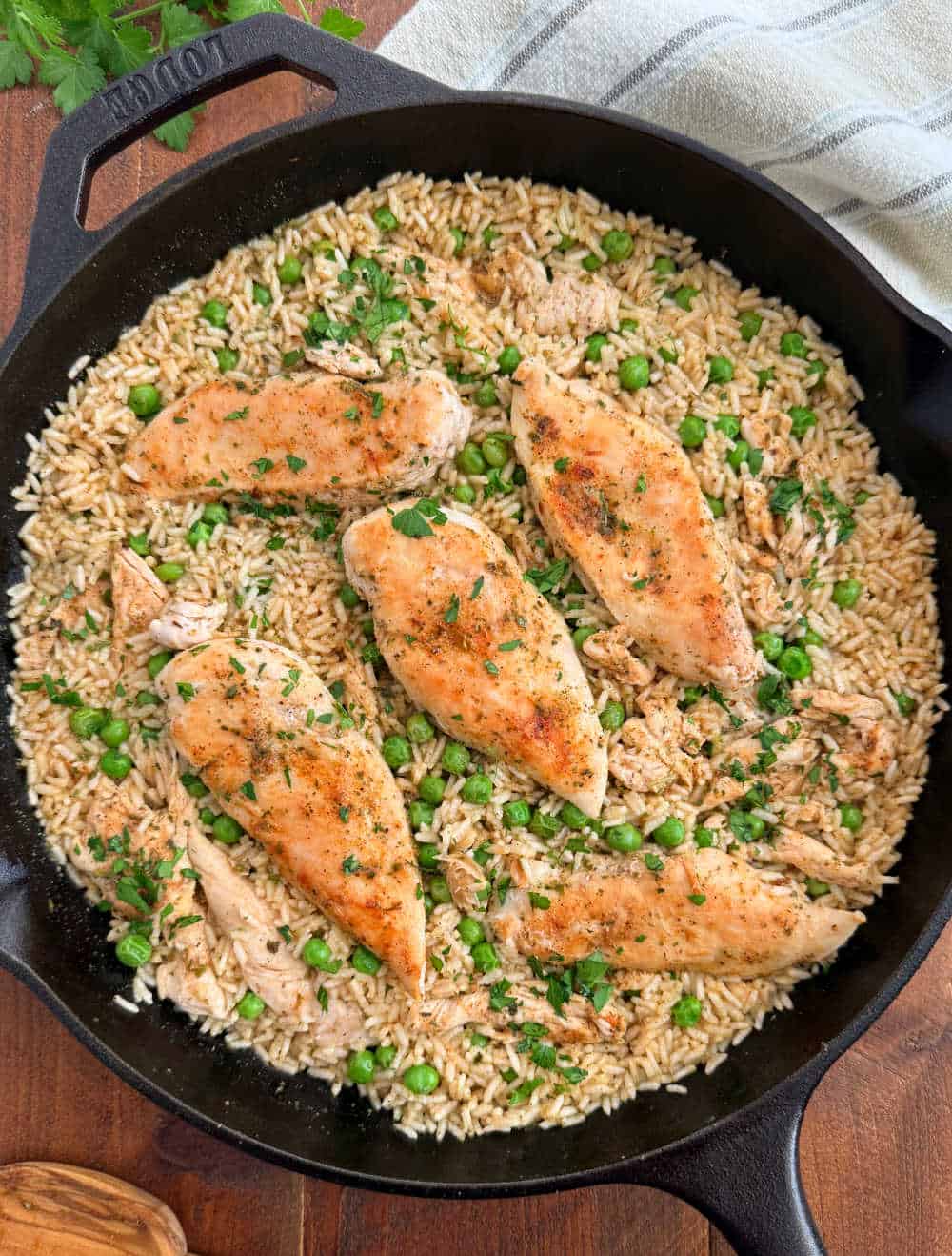 chicken and rice with peas in cast iron skillet.