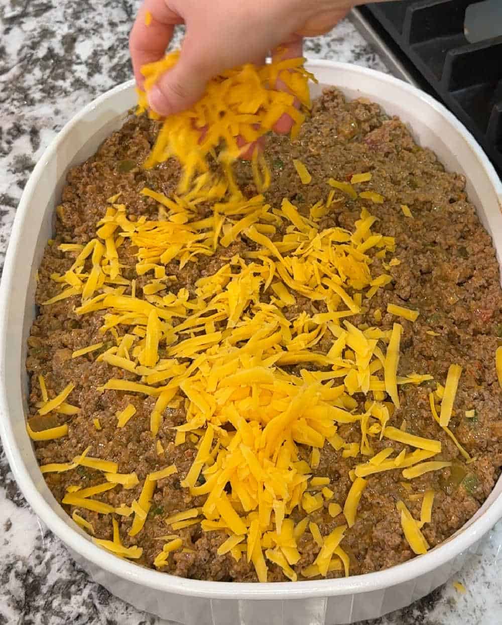 sprinkle cheese over beef.