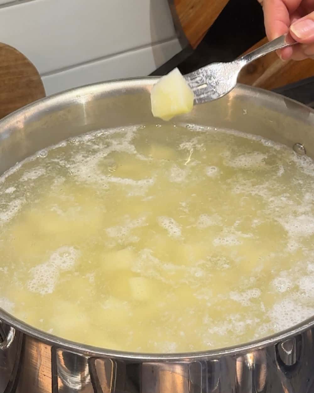 cooked diced potato on fork.