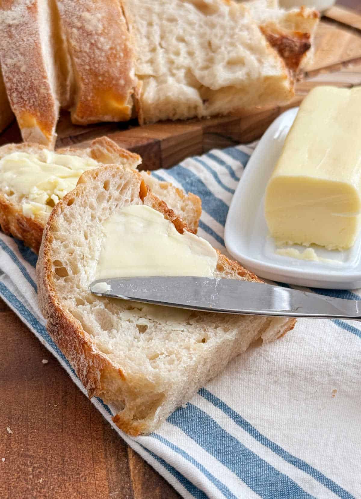 spread homemade butter on homemade sourdough bread.