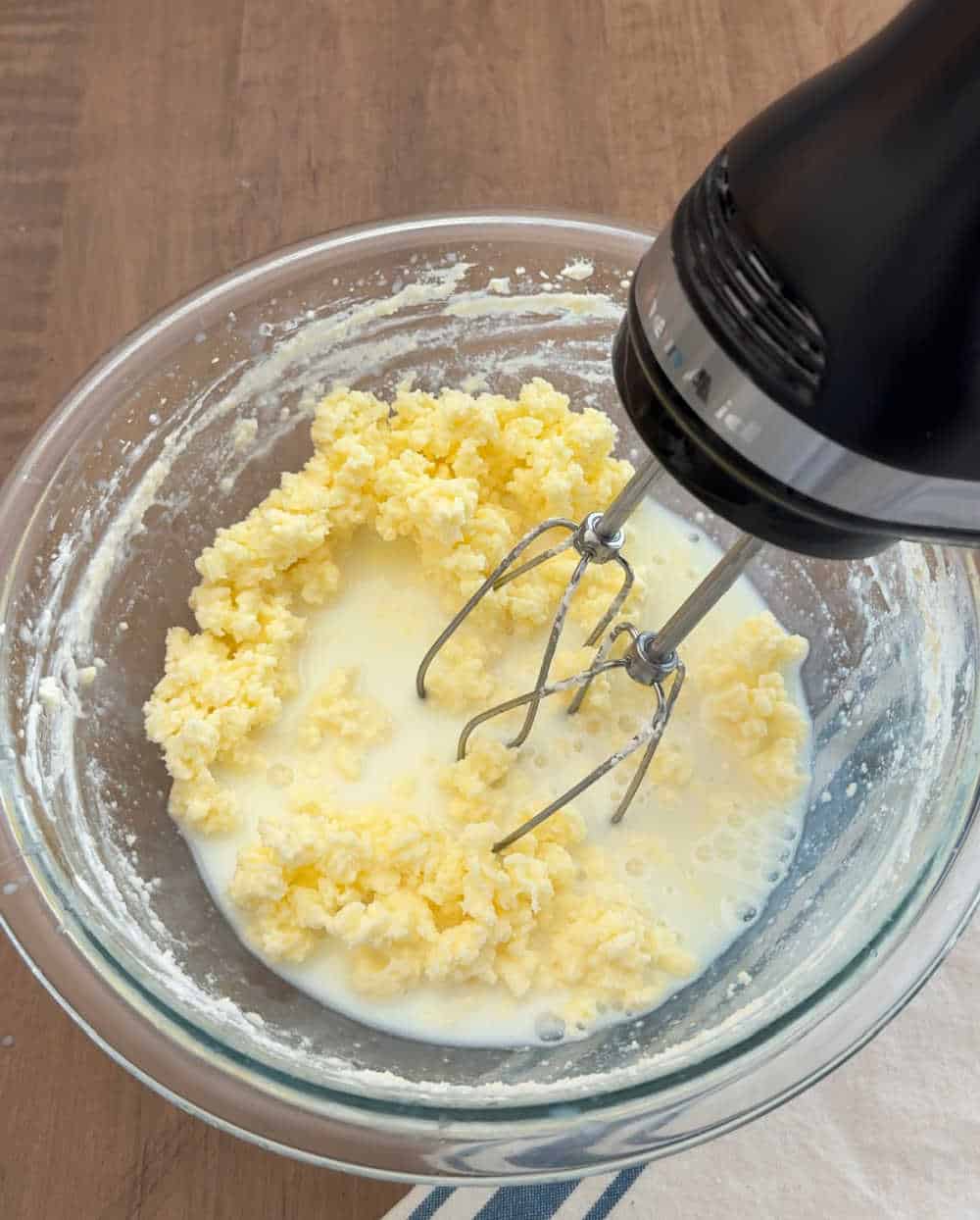 mixer turning heavy cream to butter in bowl.
