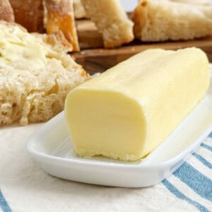stick of homemade butter on a butter dish.