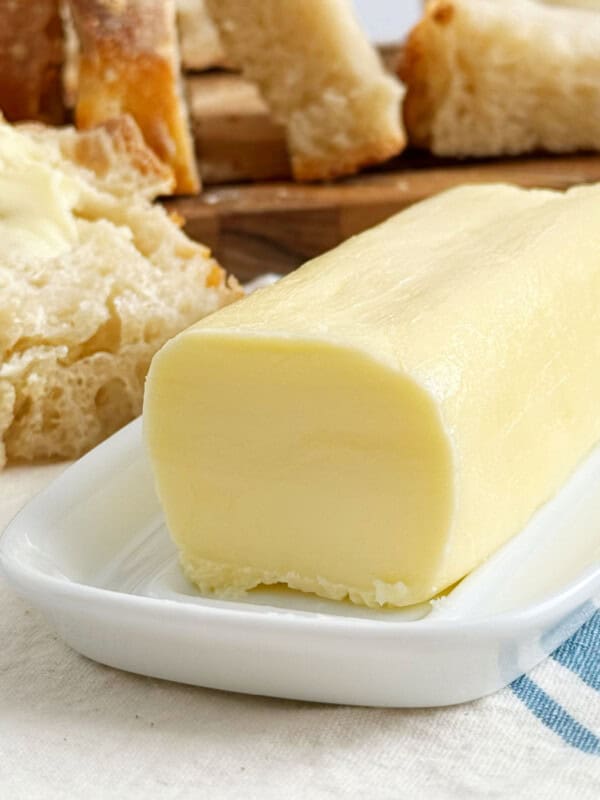 stick of homemade butter on a butter dish.