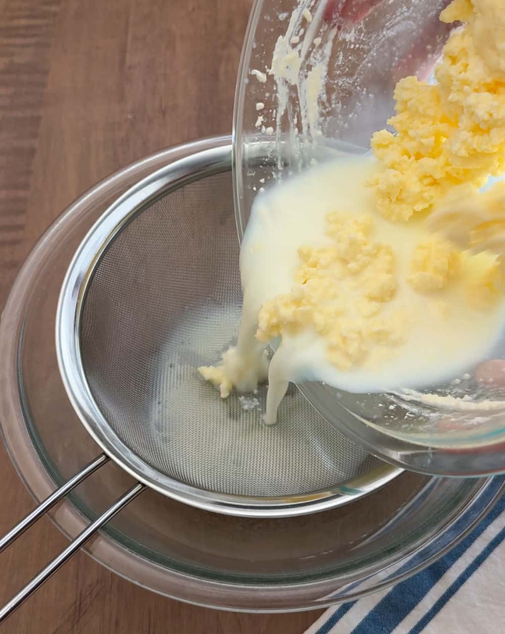 Pour buttermilk and solids into mesh strainer.