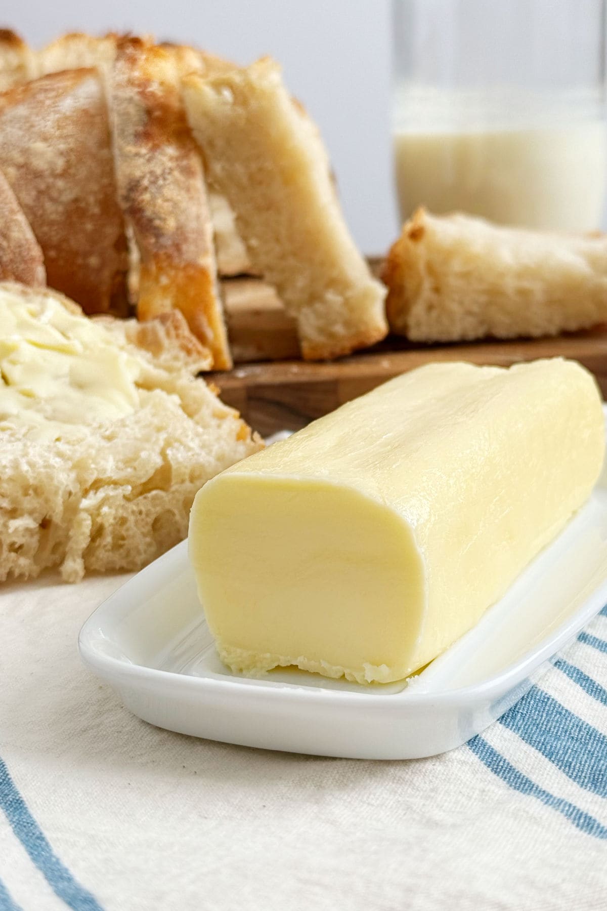 homemade butter with homemade bread and buttermilk on the table.