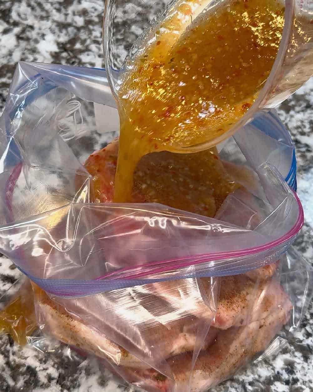 pour Italian salad dressing into freezer bag.