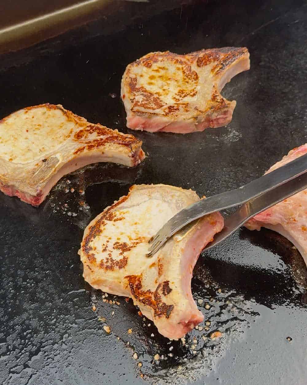 flip pork chops with BBQ tongs.