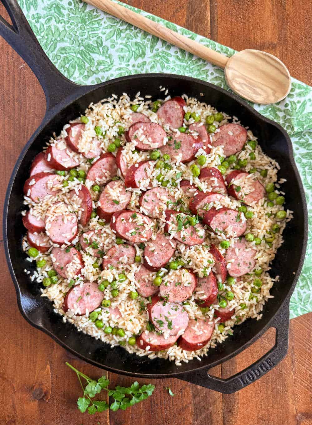 kielbasa, rice and peas in cast iron skillet.