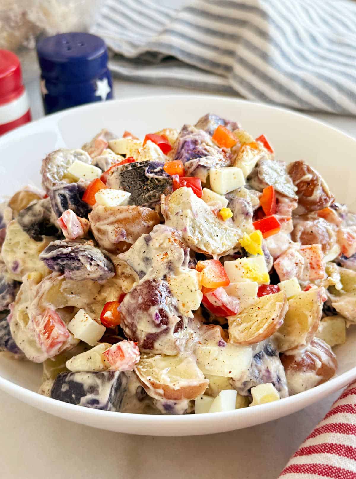 patriotic potato salad in white serving bowl.
