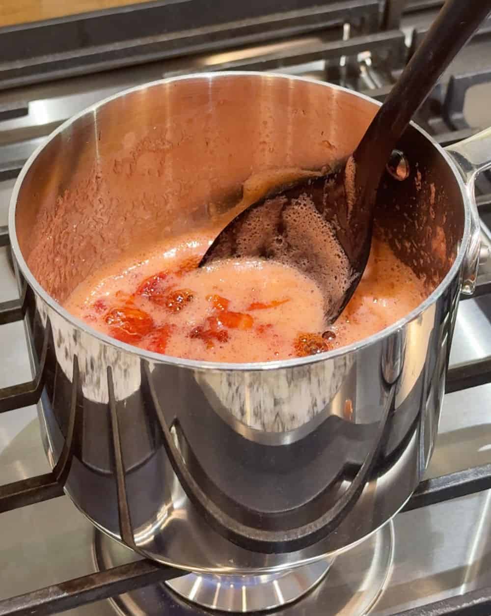 cook strawberries on stove.