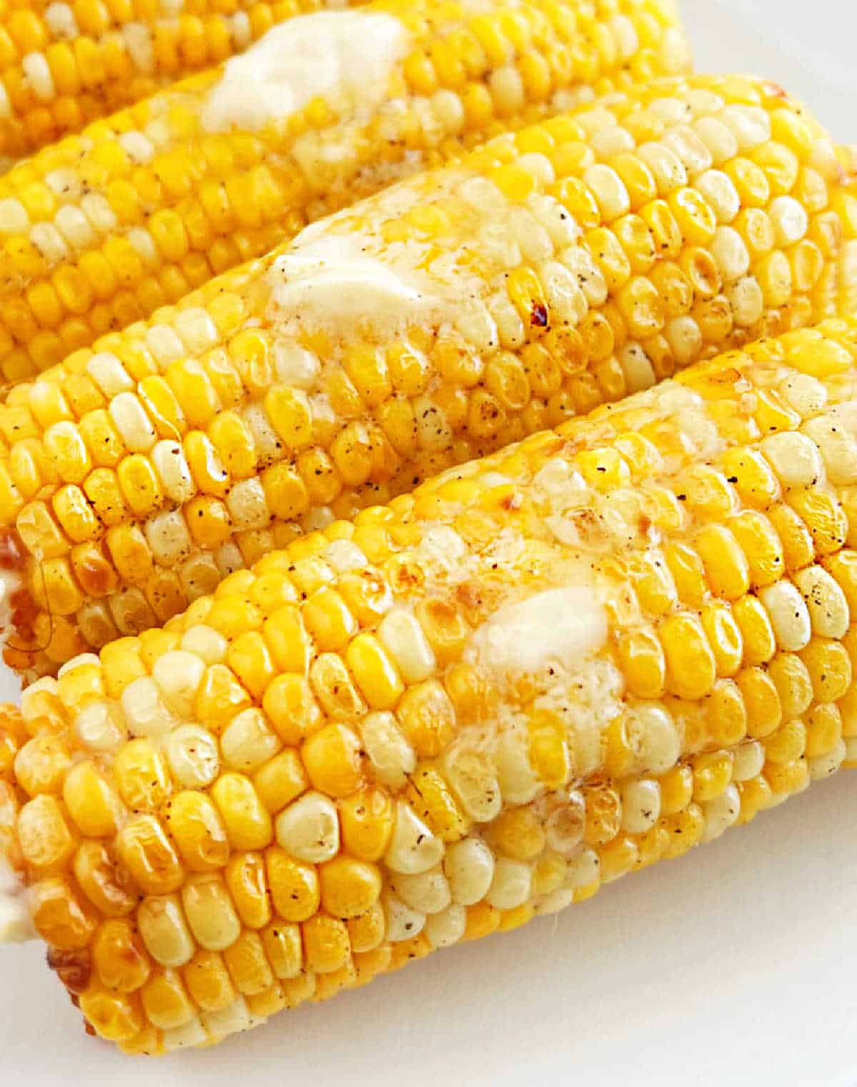 platter of corn with melted butter on top.