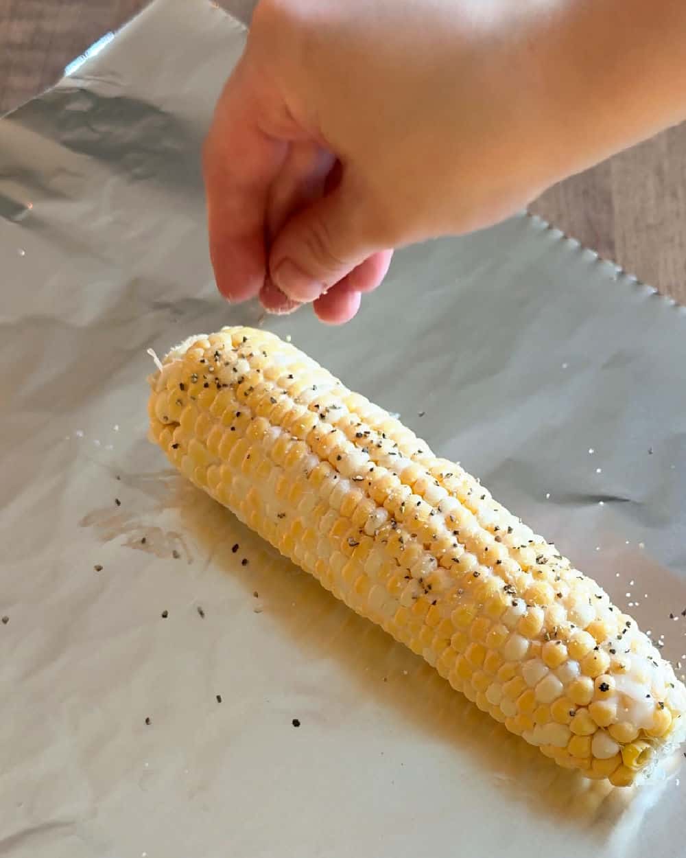 sprinkle seasoning over corn.