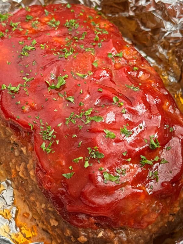 crockpot meatloaf topped with glaze and parsley.