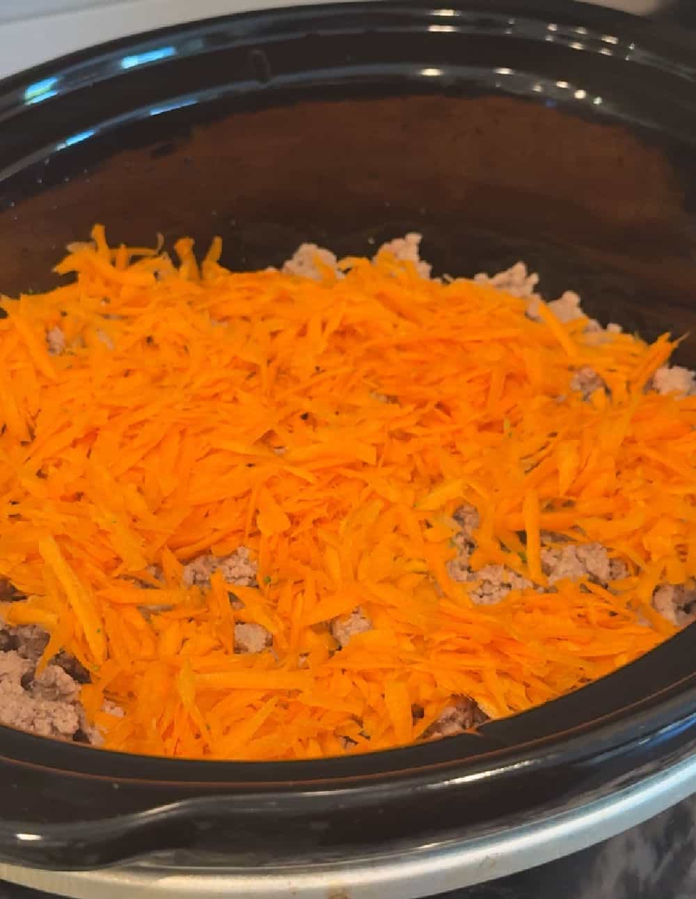grated carrots in crock pot.