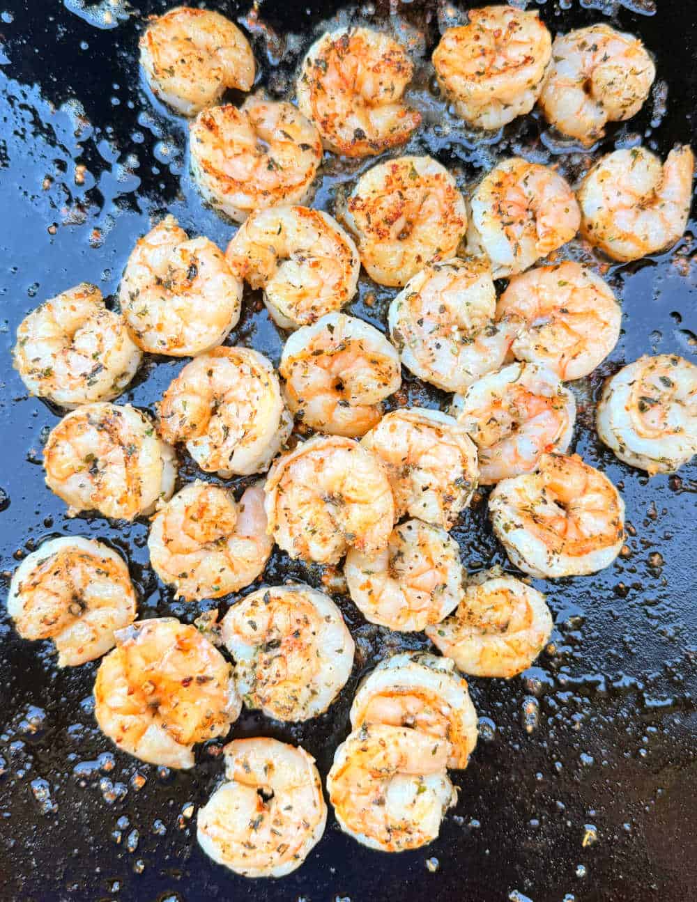 seared blackstone shrimp on griddle.