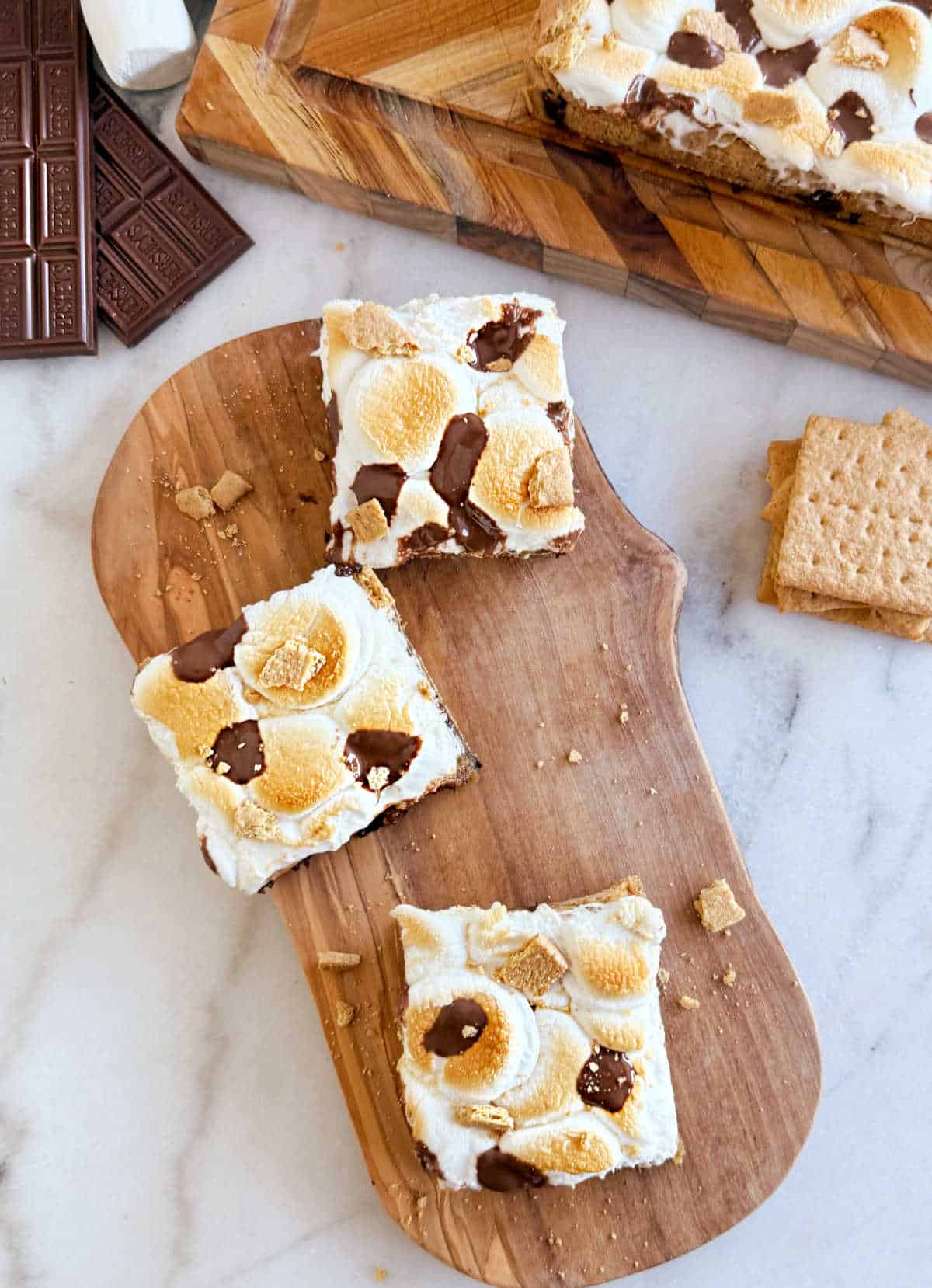 s'mores cookie bar slices on wooden board.