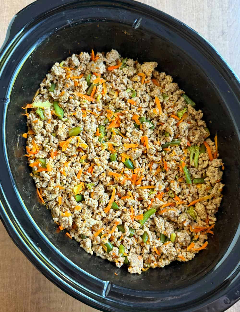 homemade dog food with ground turkey and veggies in crockpot.