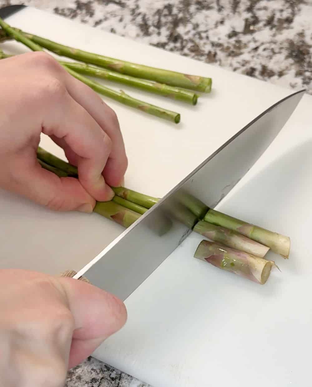 cut ends off asparagus with knife.