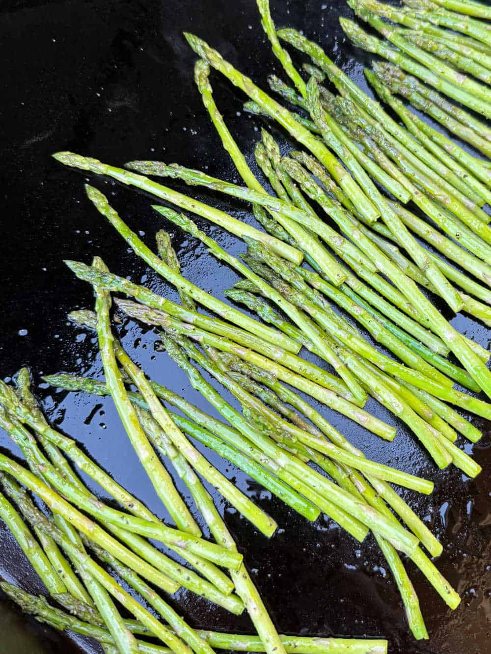 cooked asparagus on griddle.