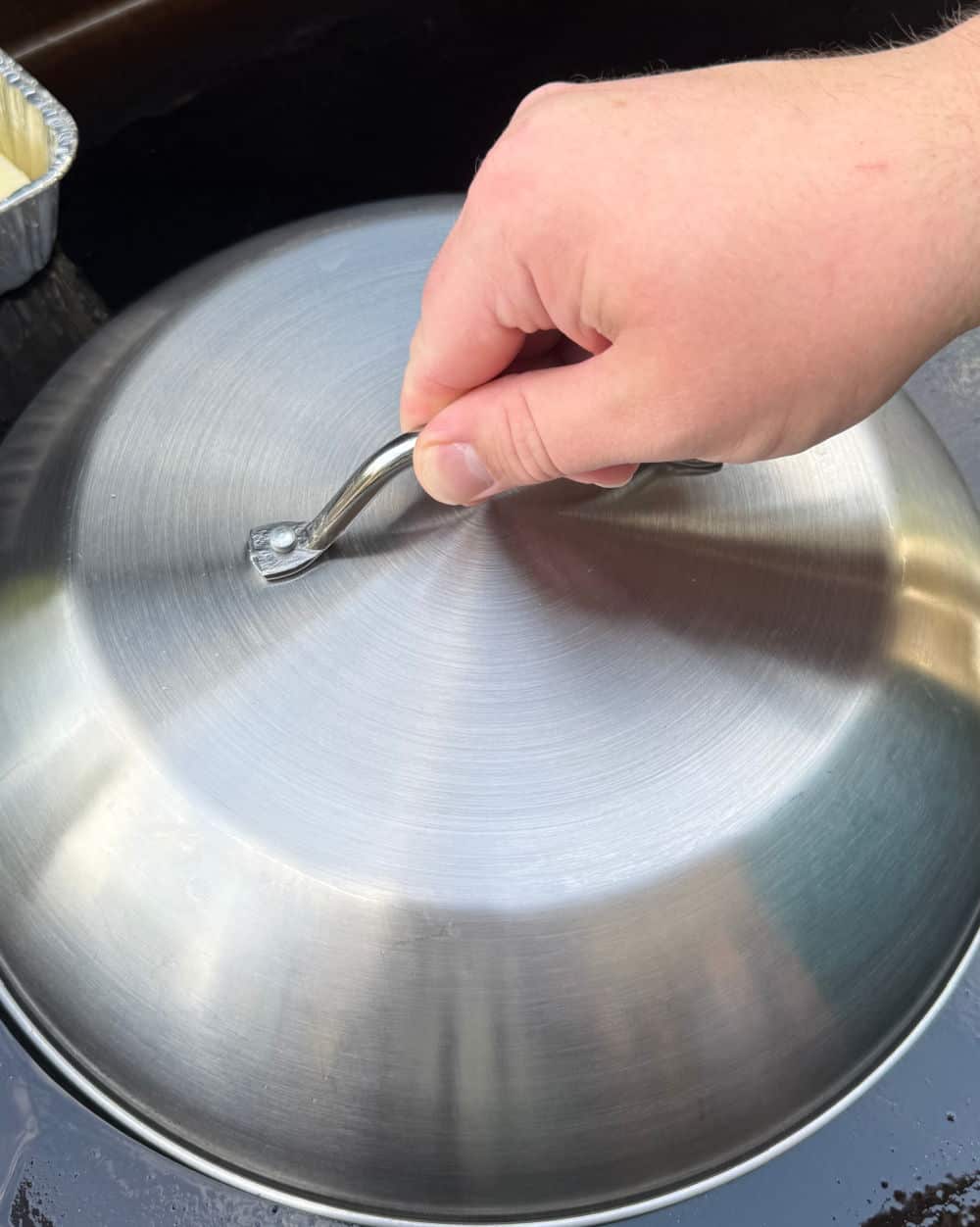 holding metal dome on griddle.
