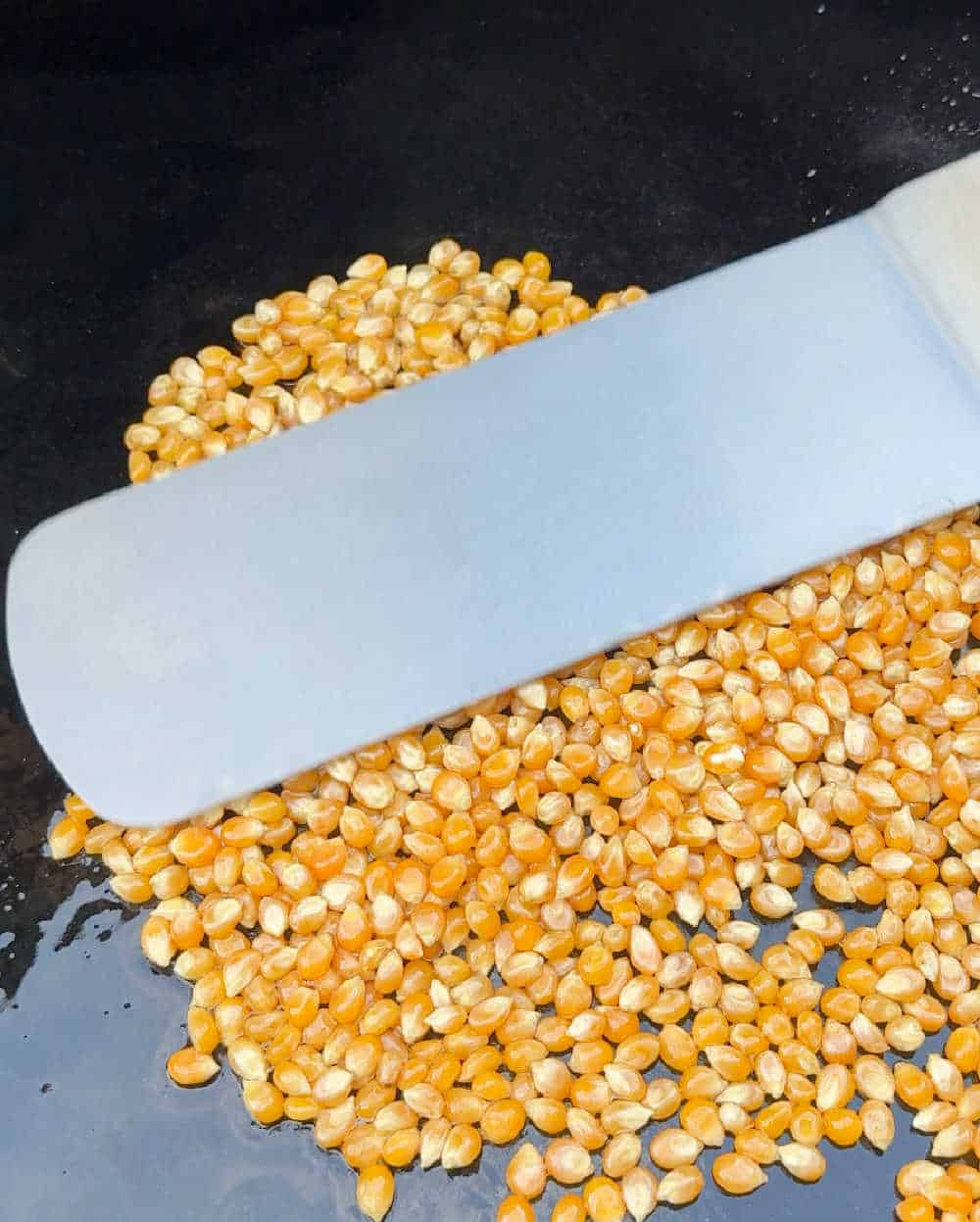 smooth kernels with grill spatula on griddle.