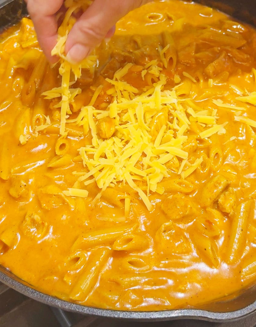 adding in shredded cheese.