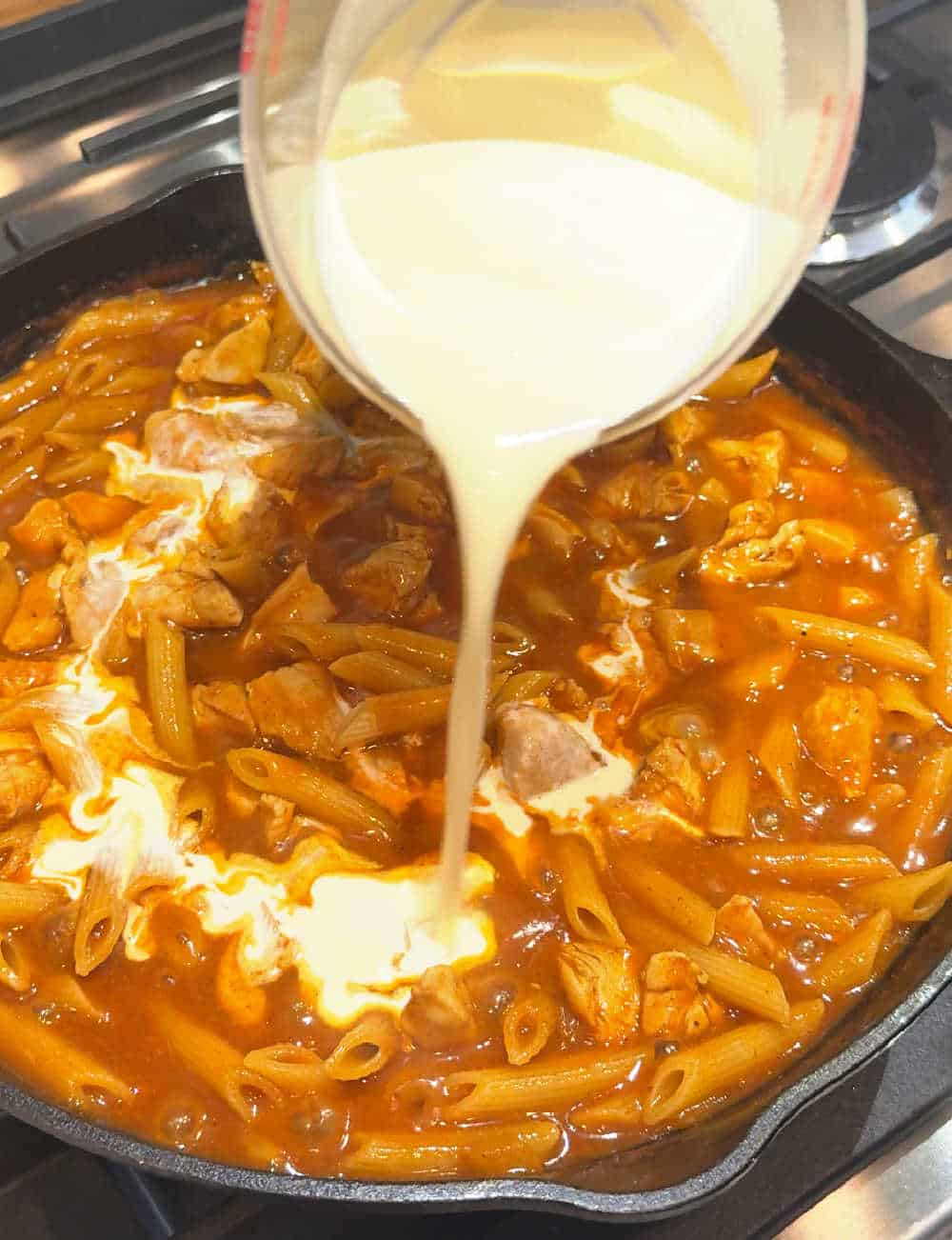 pouring in cream.