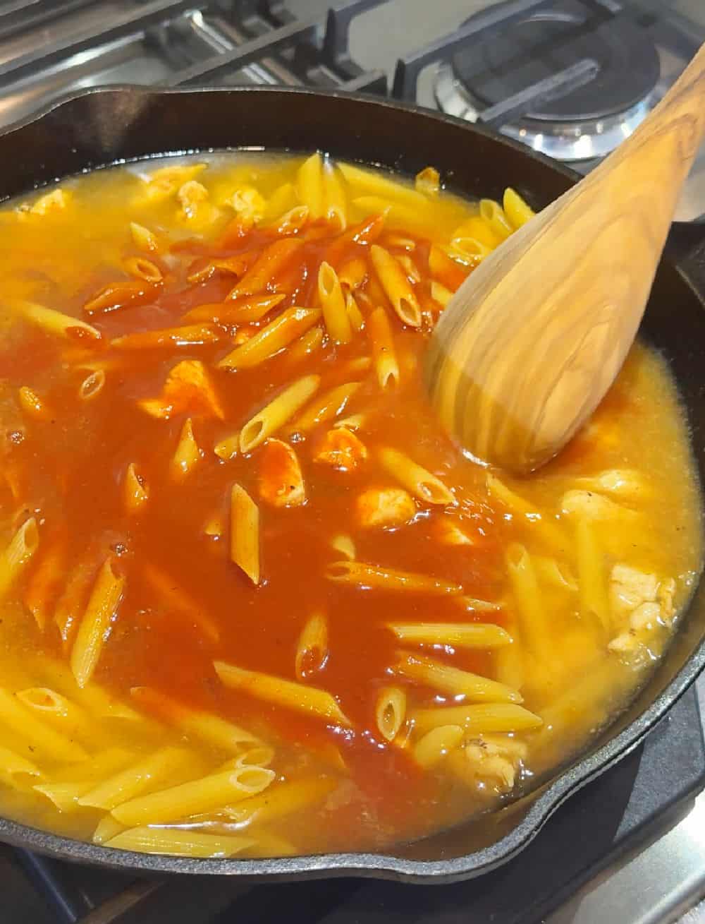 stirring in water and sauce.