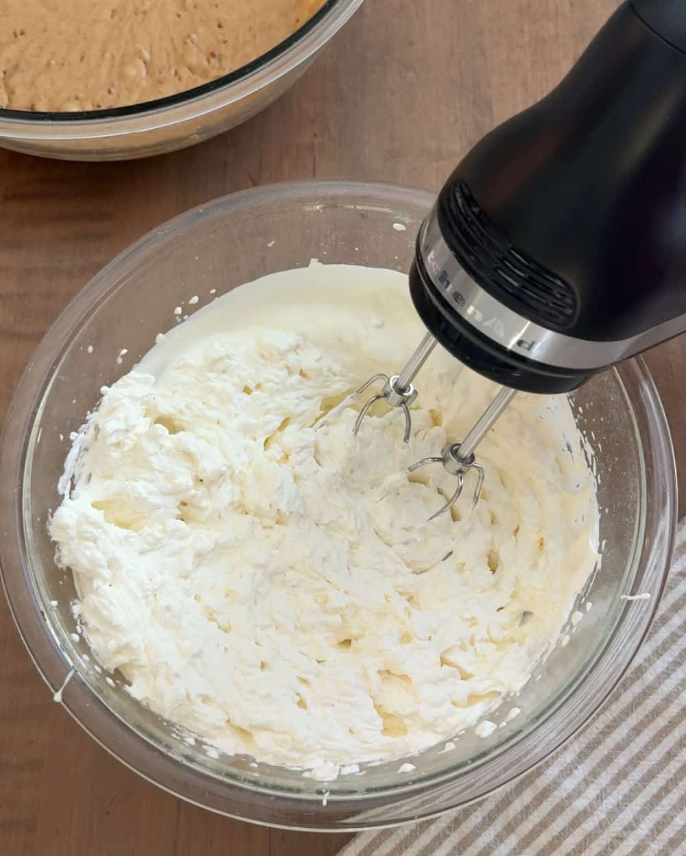 mixer and whipped cream in mixing bowl.