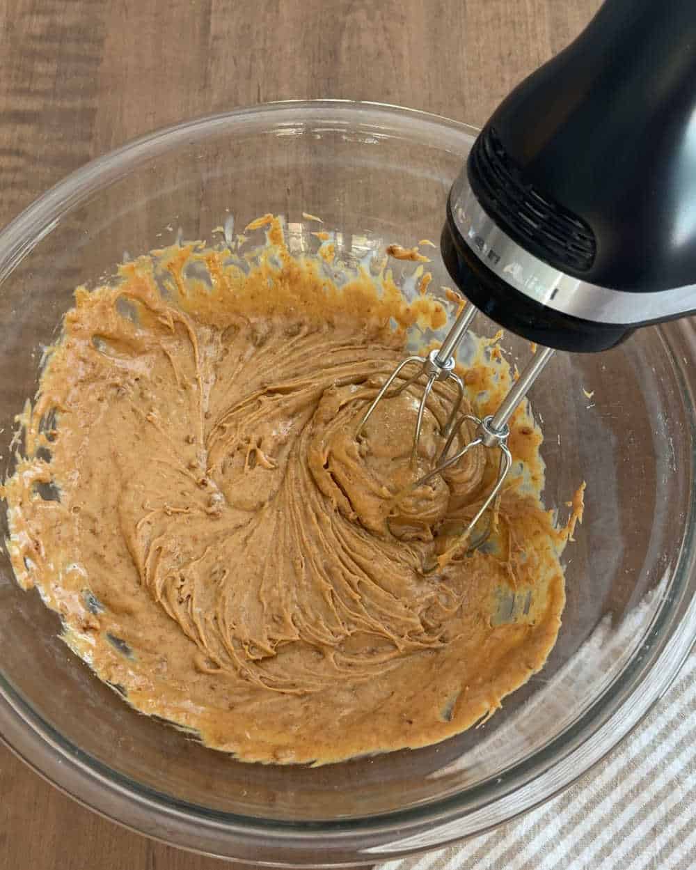 electric mixer with cookie butter in bowl.