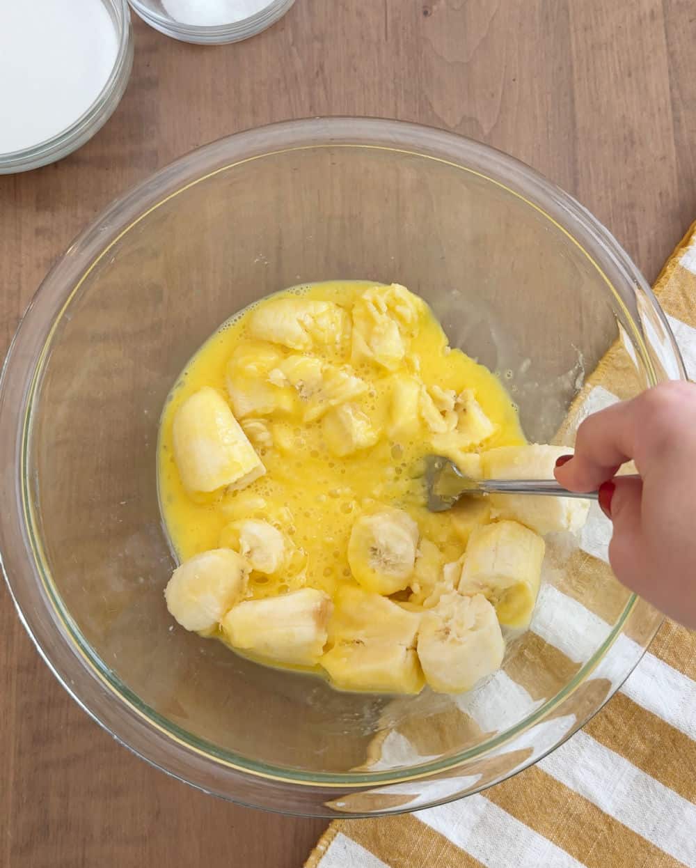 mash bananas and eggs with fork.