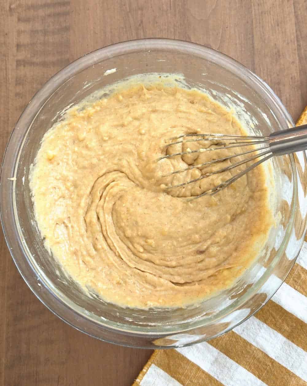 mixing batter with whisk.