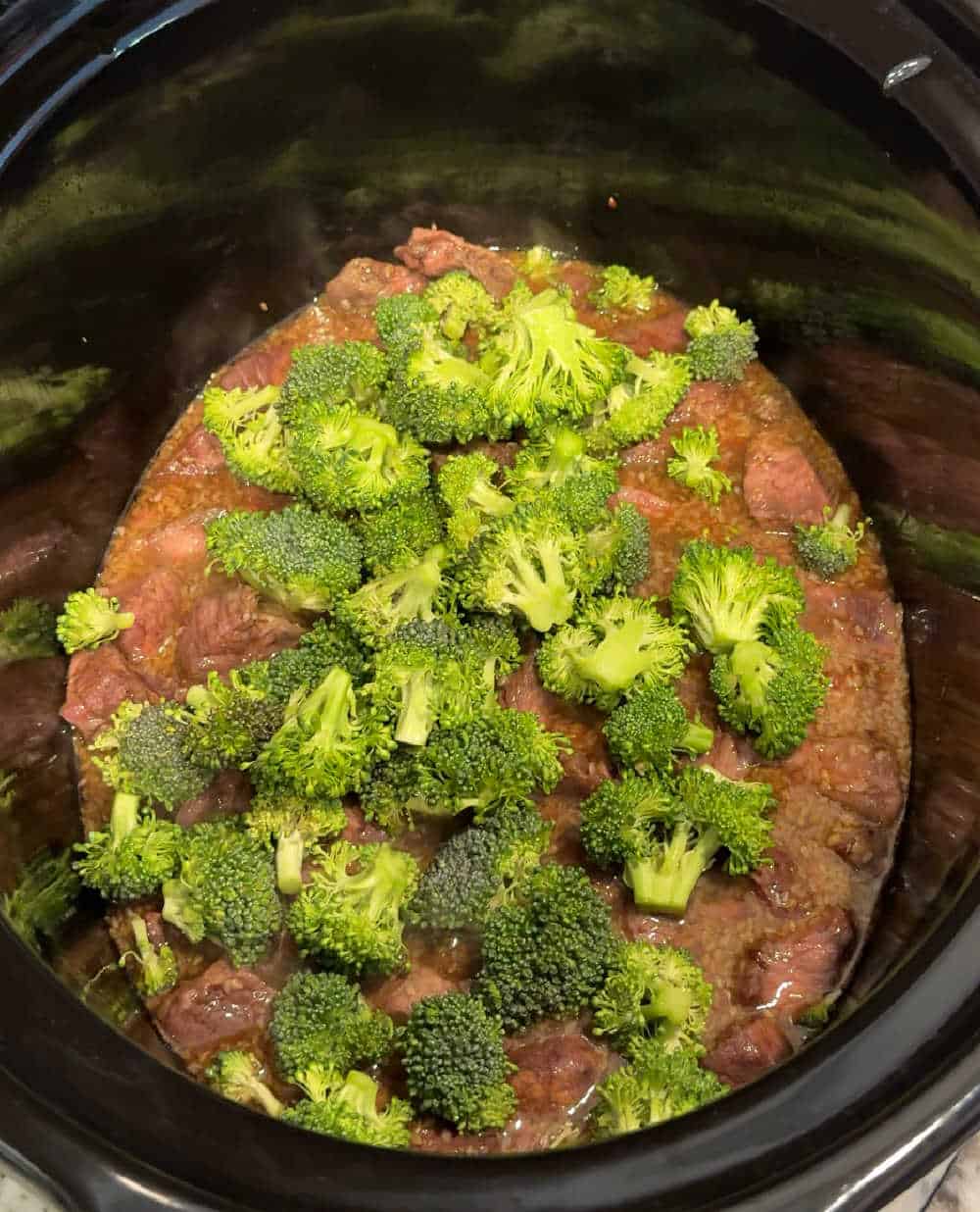 fresh broccoli over beef in crockpot.
