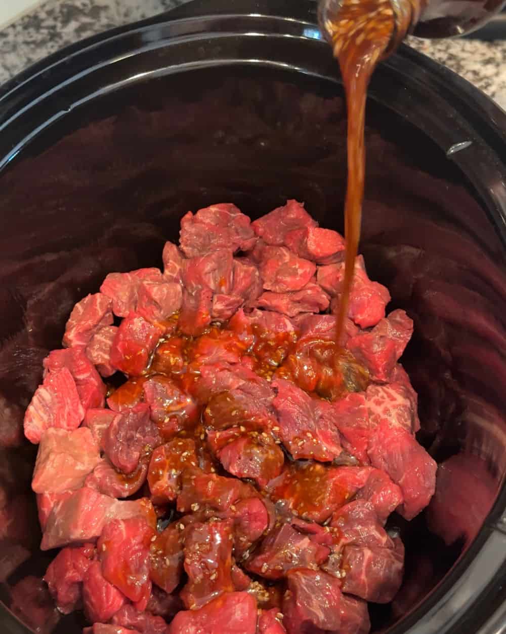 pour sauce over beef in crockpot.