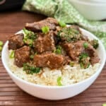 bowl of slow cooker teriyaki beef and broccoli over rice.