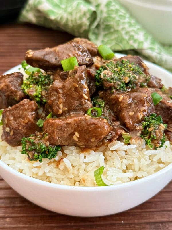 bowl of slow cooker teriyaki beef and broccoli over rice.