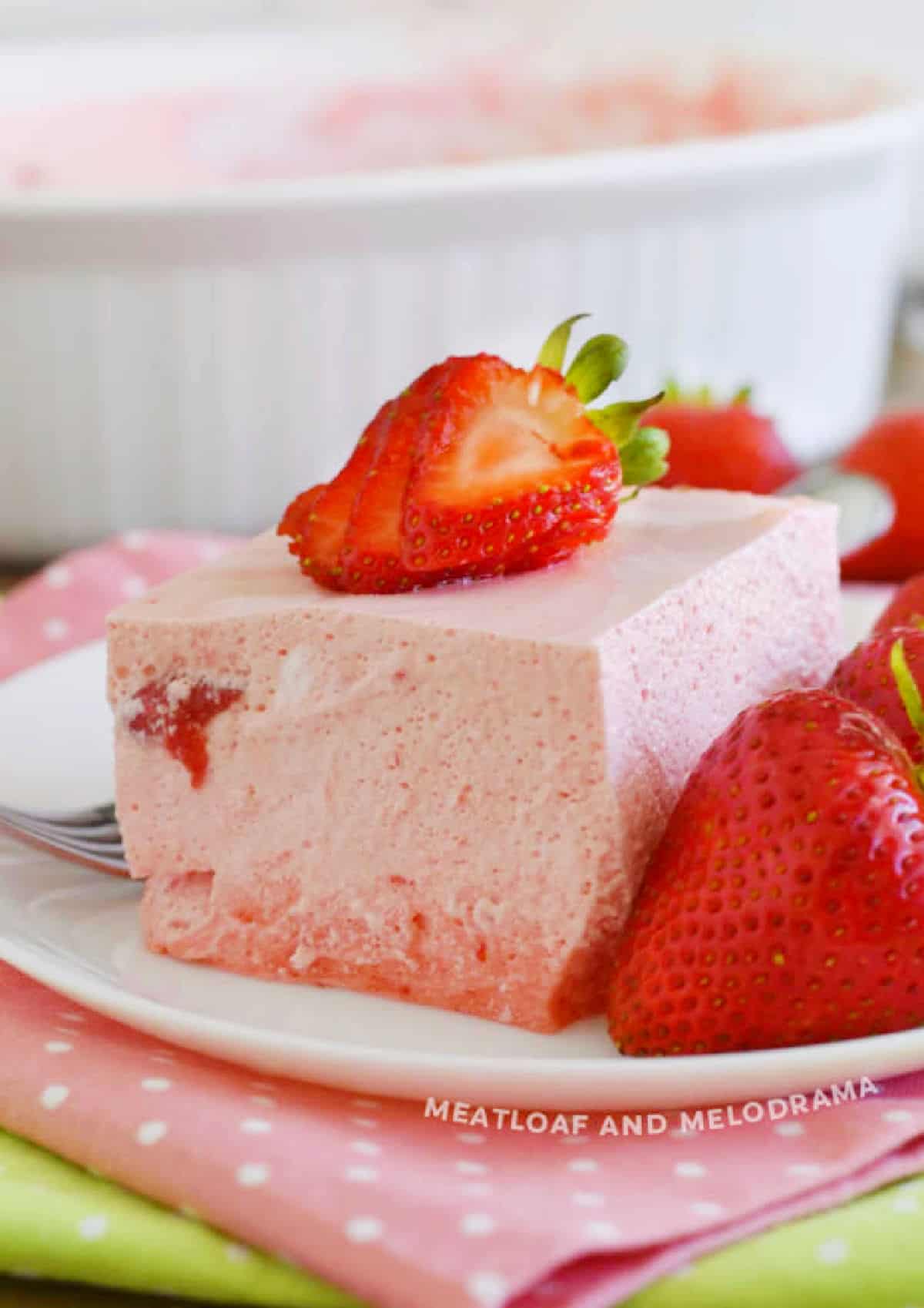 slice of strawberry jello salad on plate.
