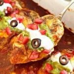 baked chicken breast with enchilada sauce, cheese and toppings on spoon.